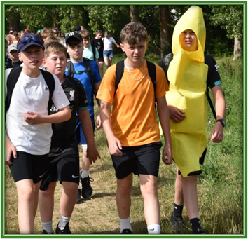 students walking and one dressed as a banana