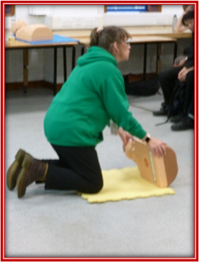 First aid trainer demonstrating CPR